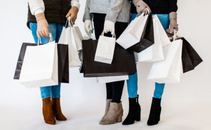 Want to know how to get more clients? Those who appreciate your work, advocate for you, and spend significant money with you? I think this article will help you. The photo is of three women talking while holding multiple shopping bags.