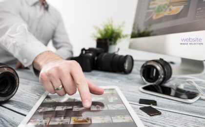 Photo of photographer helping client select images for their website.